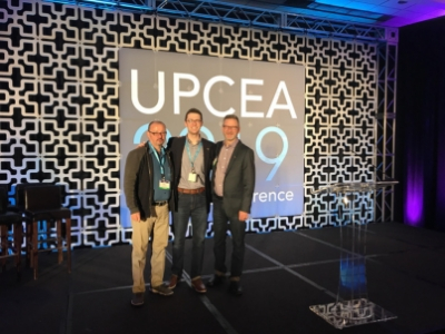 Mont Rogers, Stephen Fain, and Chris Walker posing on stage at the 2019 UPCEA Annual Conference