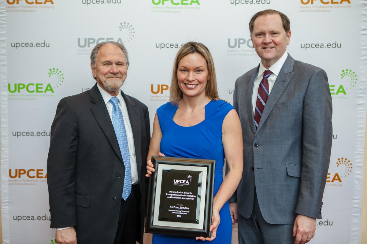 Stefany Sanders poses with Dorothy Dunkin Award and UPCEA President