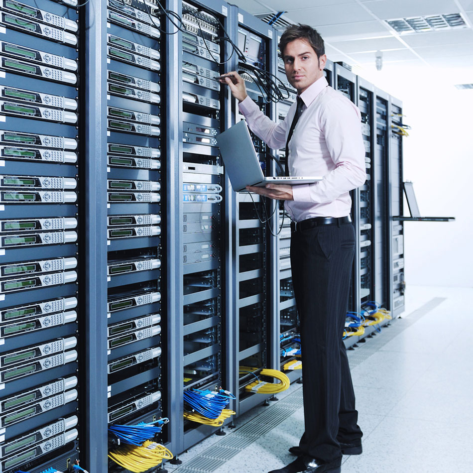 Picture of man standing at server rack