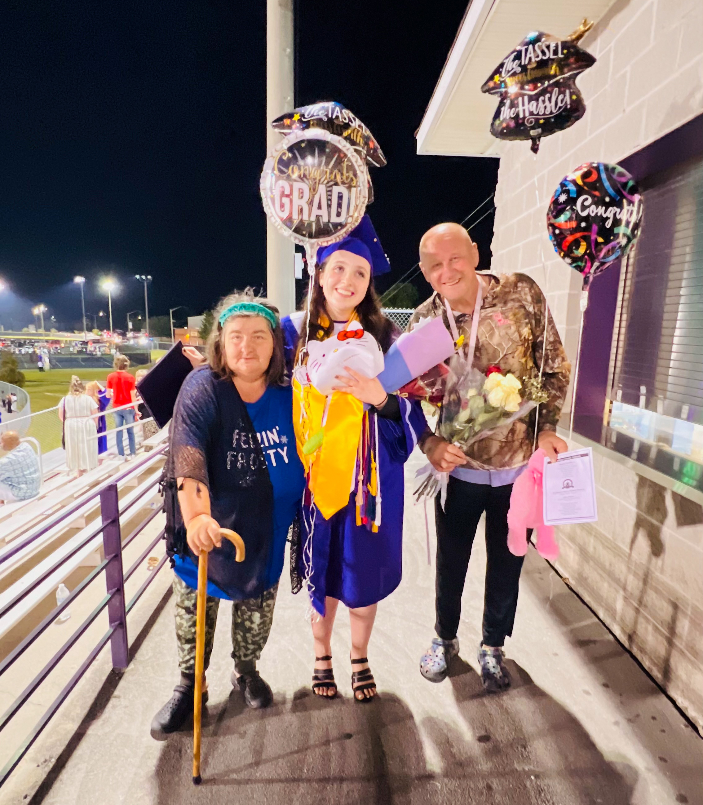 Angela Juric (middle) with her mother (left) and father (right) at her high school graduation.