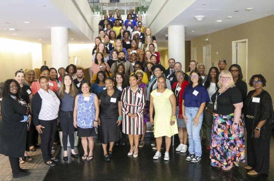 Individuals participating in the 2023 cohort are lined up on a stairwell. 