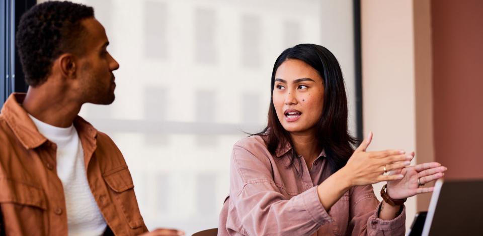 A man and woman discussing topics in the workplace