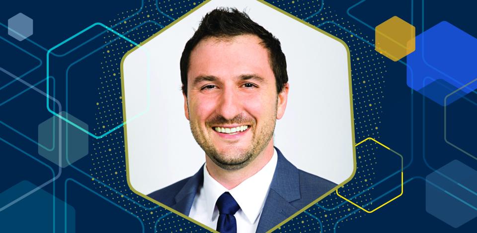 A professor, shown in a close-up portrait against an abstract graphic backdrop.