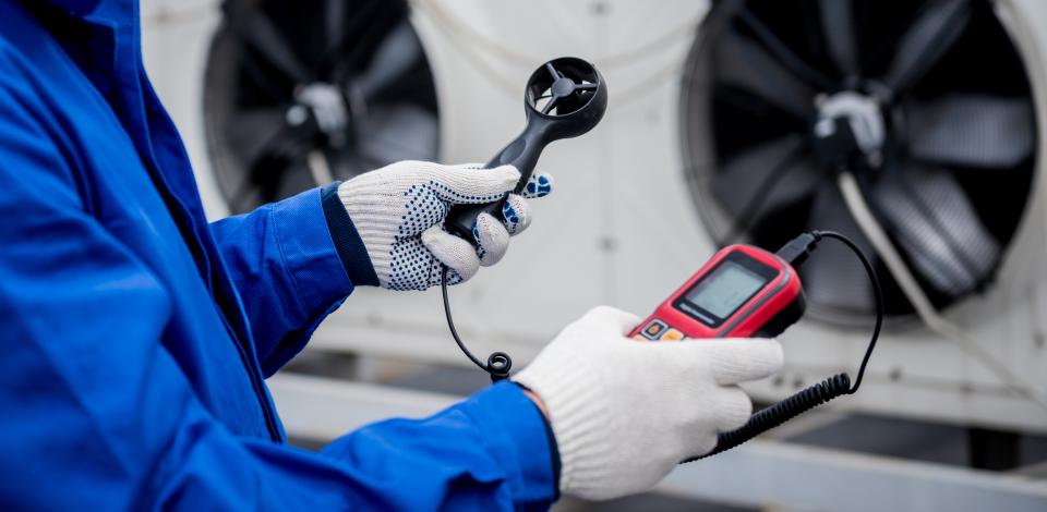 An industrial hygienist testing air quality. 