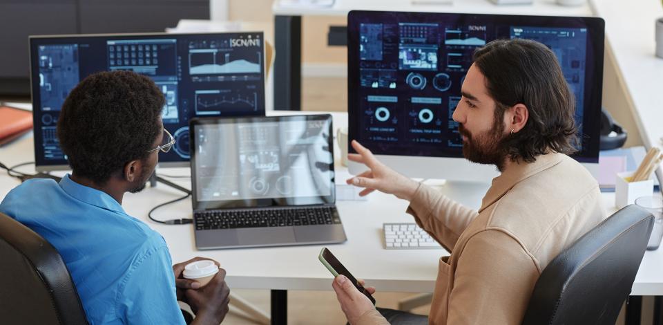Two coworkers discussing data dashboards
