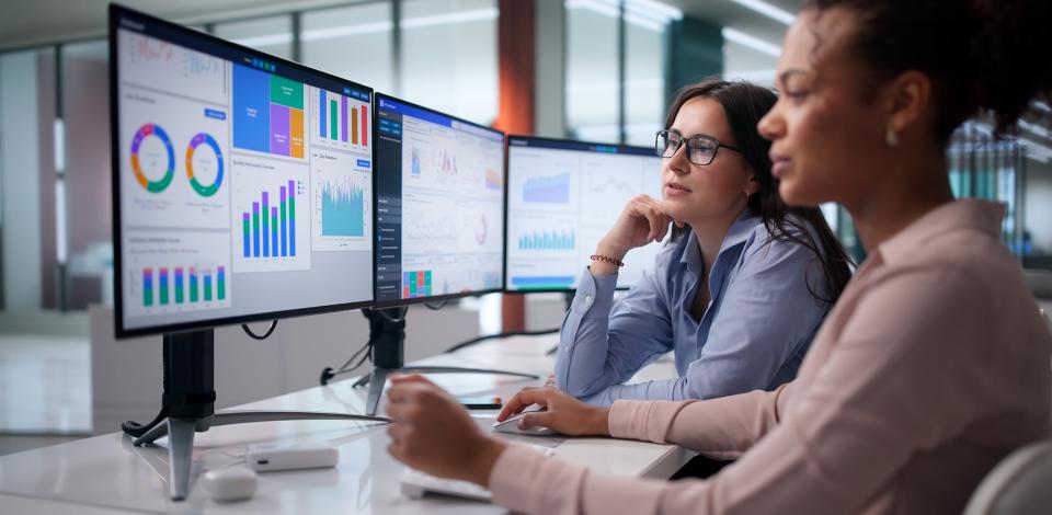 Two female business analysts reviewing data.