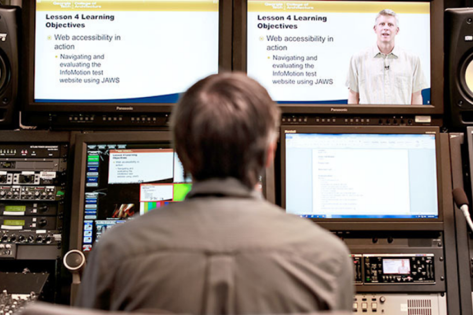 Man sitting in front of controller editing recorded classroom footage