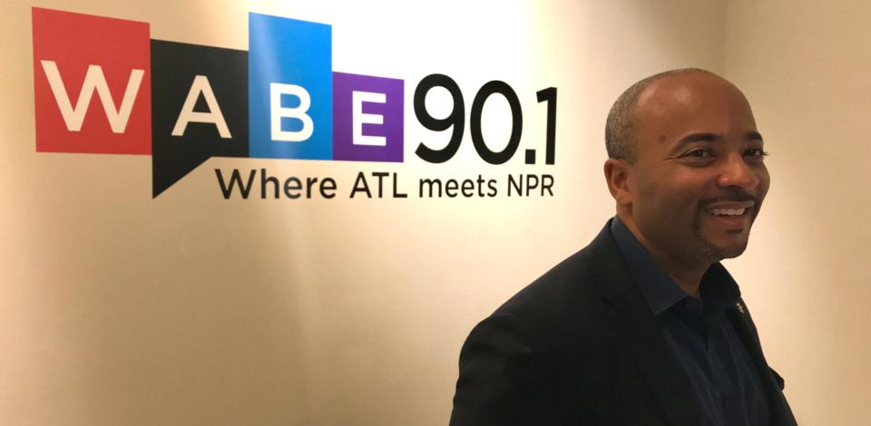 Raheem Beyah standing in front of WABE 90.1 logo