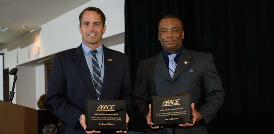 James Wilburn and Ken Harrison standing with award plaques