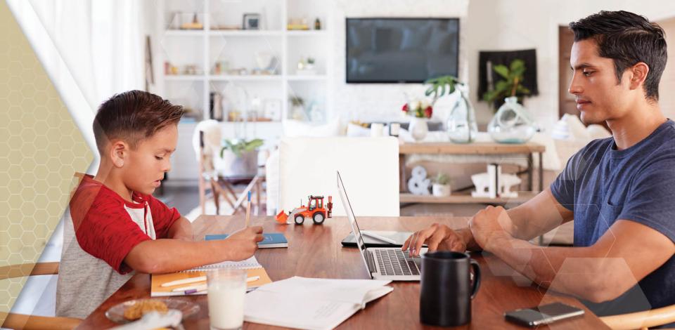 Dad works from home while helping son with homeschool