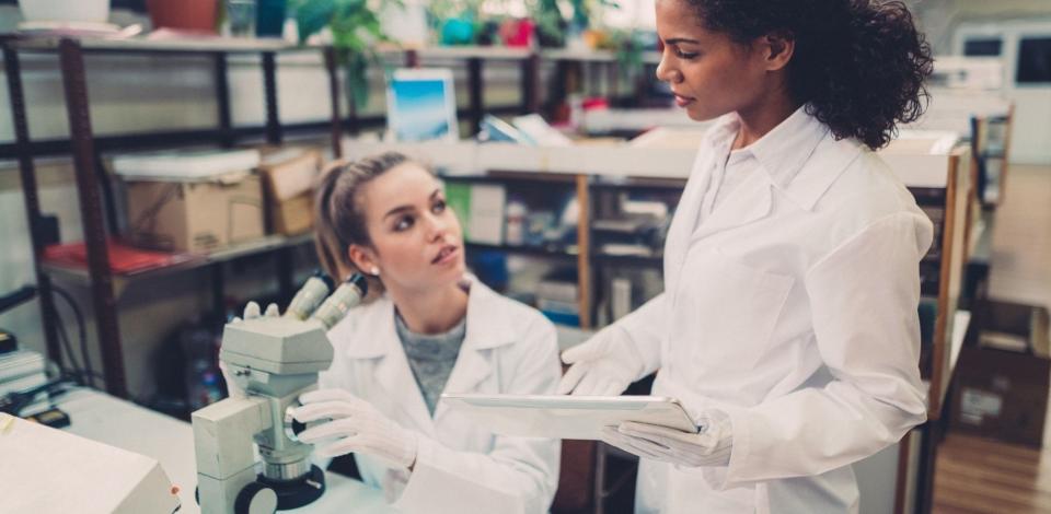 Young women working in electronics industry as quality control