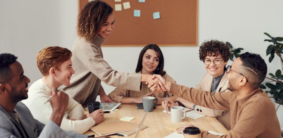 Work colleagues collaborating across a conference table