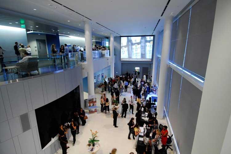 Attendees standing in the atrium at a conference