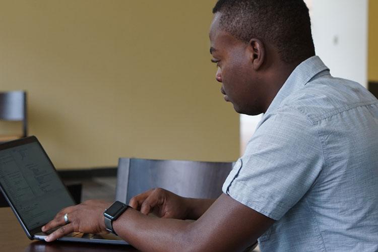 Computing professional working on laptop computer