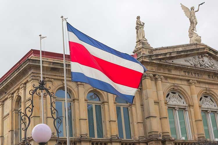Costa Rica flag flying in front of government building