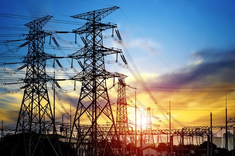 Picture of several power towers against a sunset