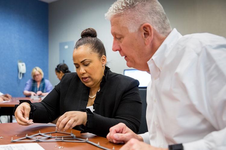 Management professionals collaborating in classroom