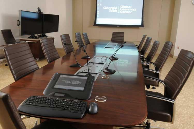 Conference table and projection screen in the video conference room