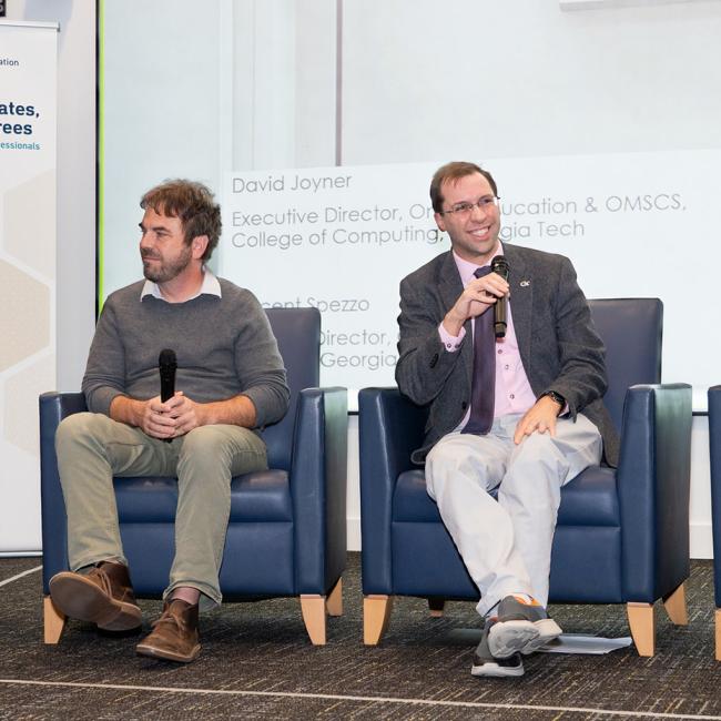 Four panelists at the 2023 Affordable-Degrees-at-Scale Symposium are sitting on a stage discussing scaled online degree programs.