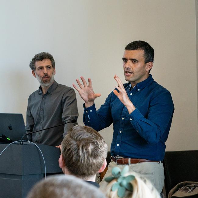Two men giving a presentation at a cybersecurity conference.