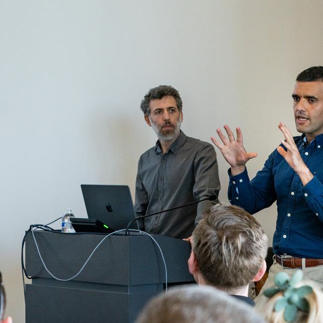 Two men giving a presentation at a cybersecurity conference.