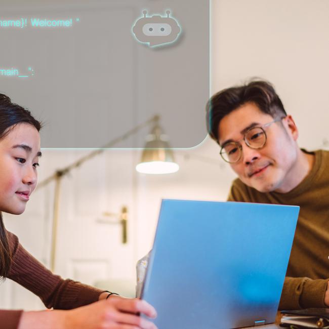 Man and woman using AI to code on a laptop