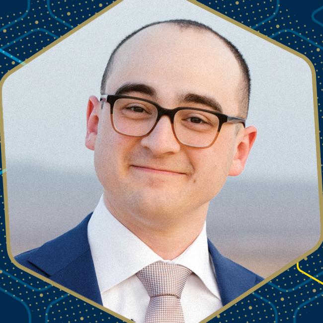 A professor, shown in a close-up portrait against an abstract graphic backdrop.