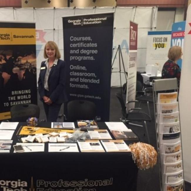 Theresa Atkins standing being the Georgia Tech booth